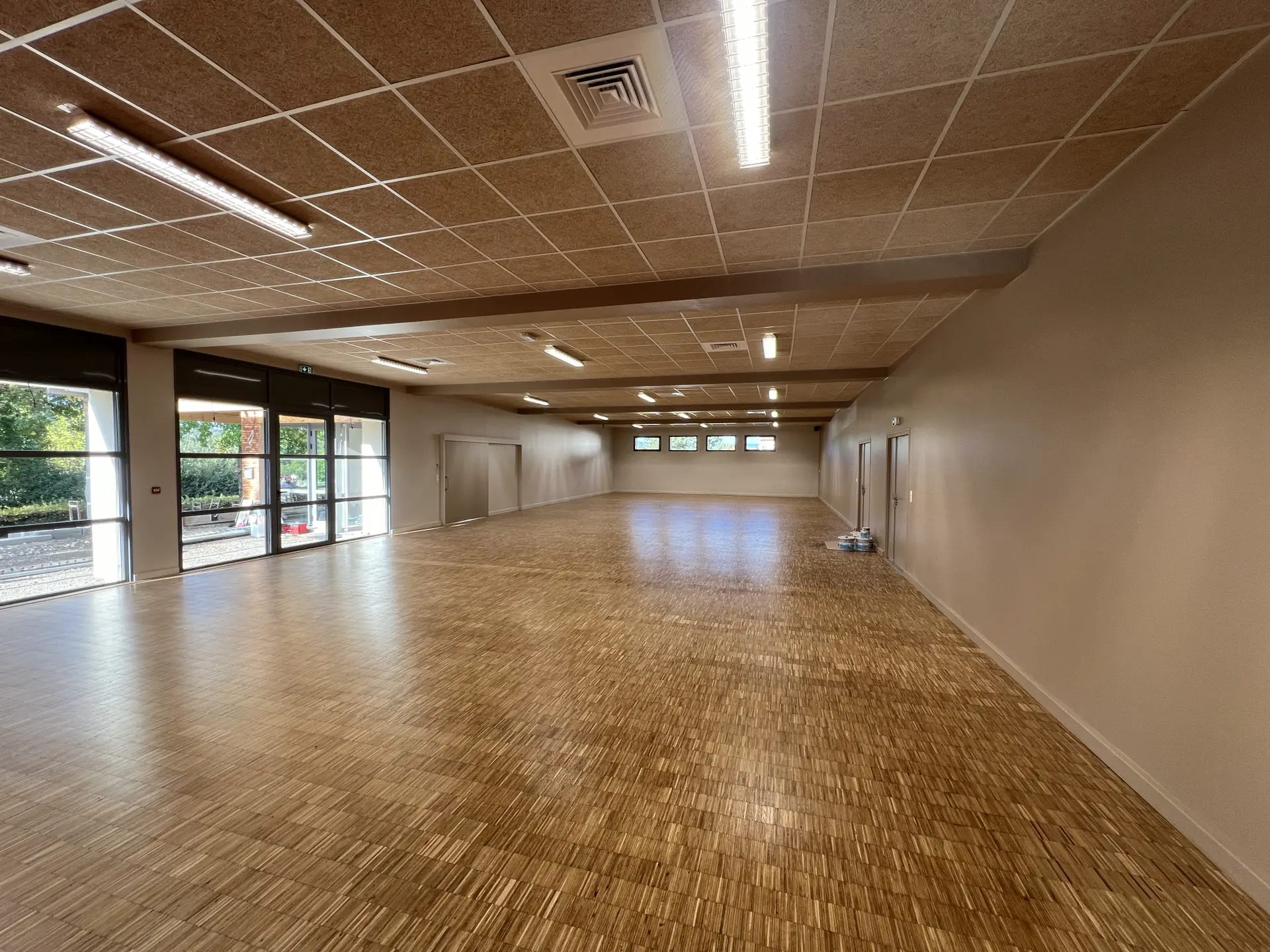 Grande salle communale avec parquet et baies vitrées à Vernioz, en Isère